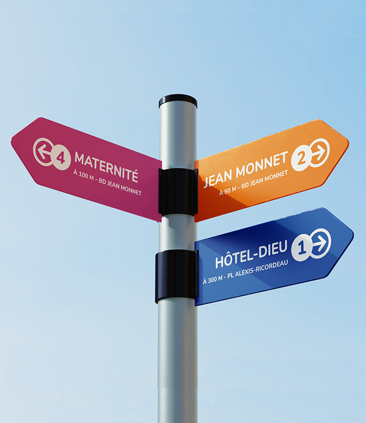 Panneaux signalétique colorés à l'extérieur de l'hôpital, indiquant clairement les directions vers les différents services médicaux avec des couleurs distinctives pour chaque zone.
